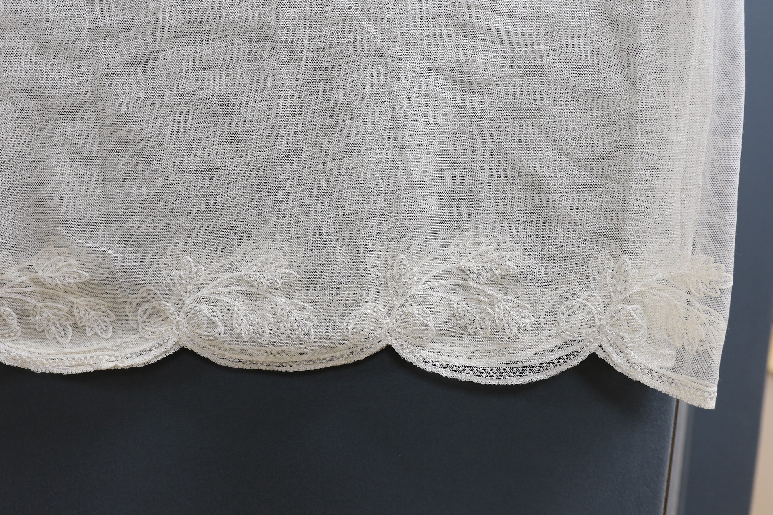 An early 20th century machine lace wedding veil, 120 cms x 186 cms